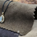 Elegant gold pendant with pear cut diamond centerpiece