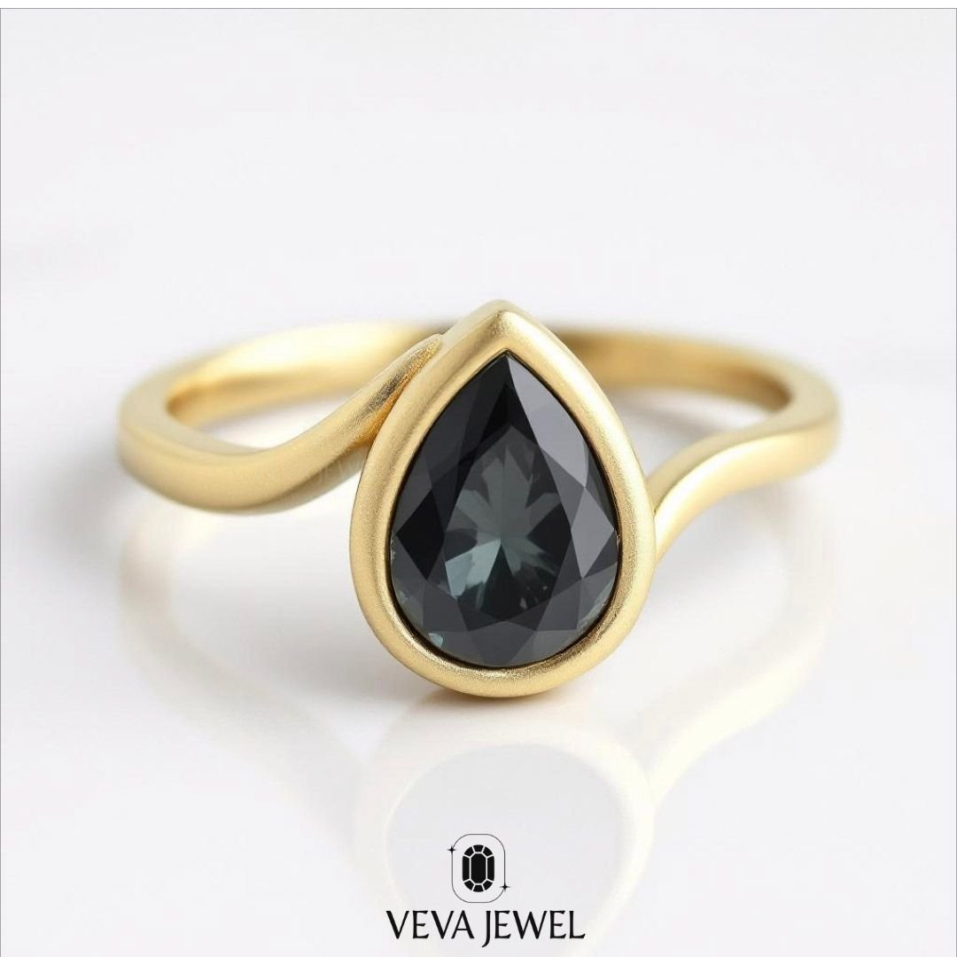 grey pear cut moissanite engagement ring in yellow gold