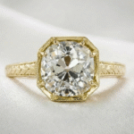 old mine cut moissanite ring in yellow gold bezel setting