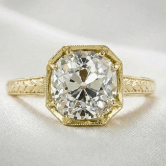 old mine cut moissanite ring in yellow gold bezel setting