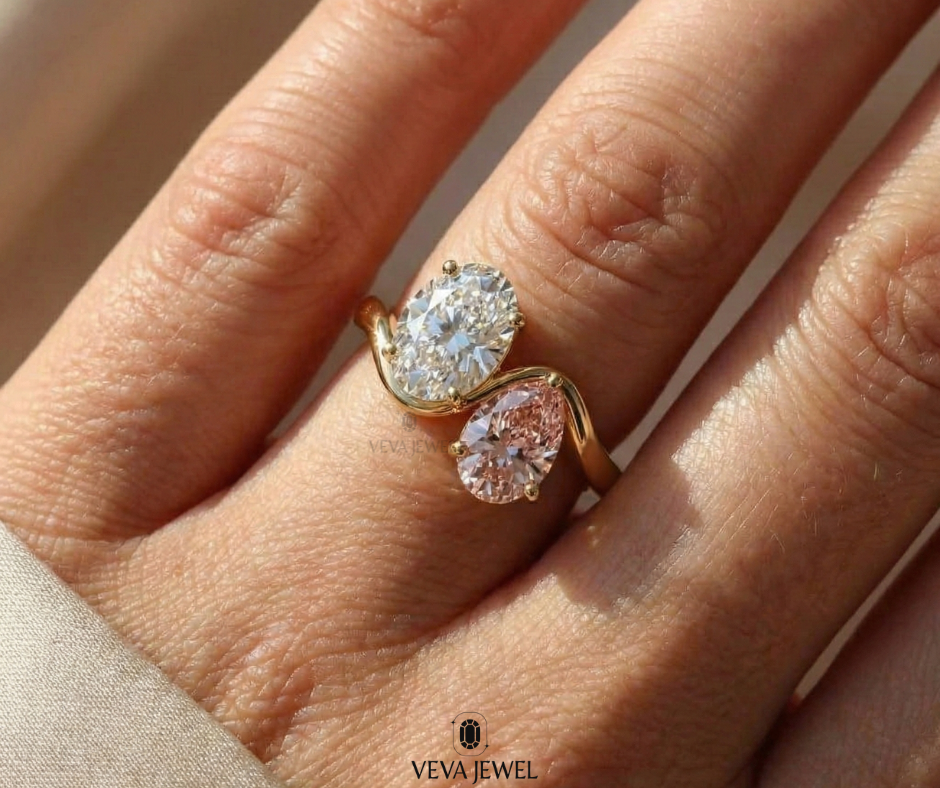 Gold crossover ring featuring oval moissanite and pink gemstone