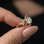 antique style round cut engagement ring with leaf details